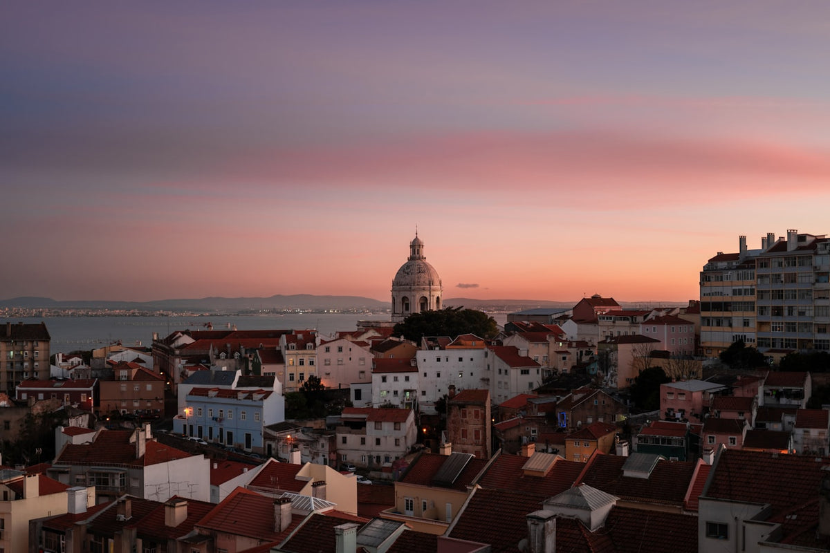 Lisbon skyline glowing at sunset over the rooftops